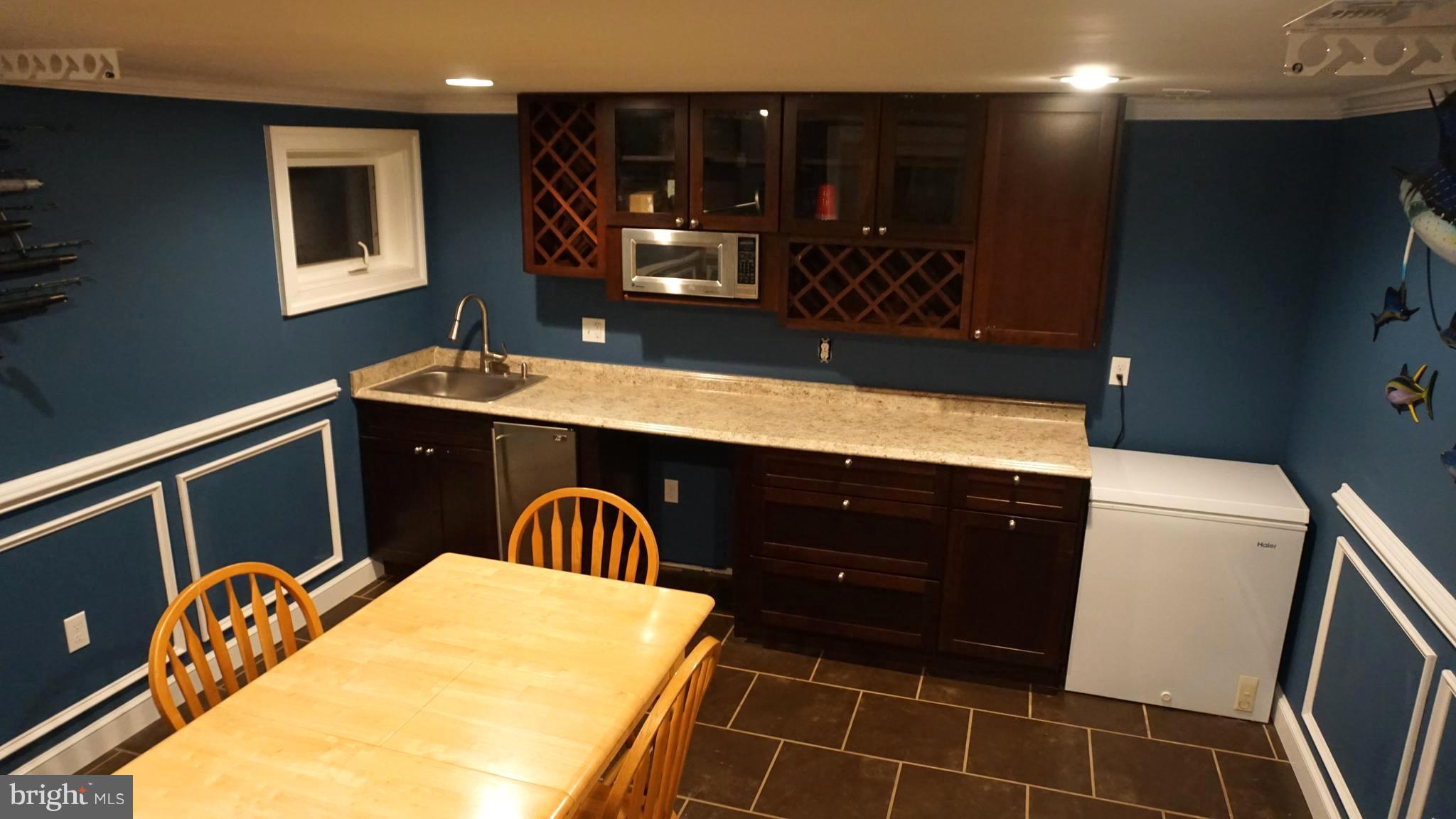 9105 Cuckold Point Road Baltimore, MD 21219 - Photo 63 of 150 a kitchen with a sink and wooden floor