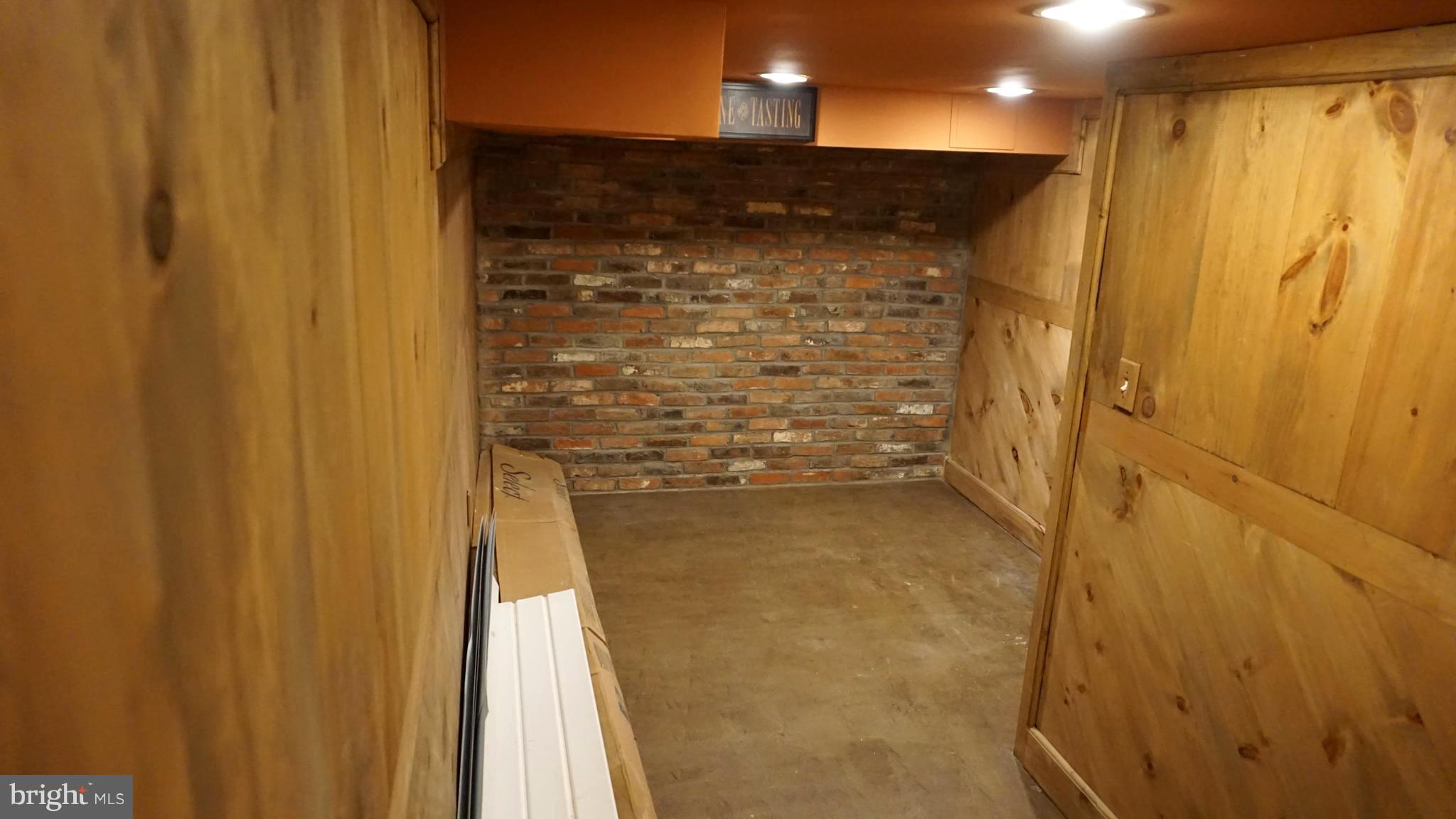 9105 Cuckold Point Road Baltimore, MD 21219 - Photo 69 of 150 Lower level wine room. Brick from little italy