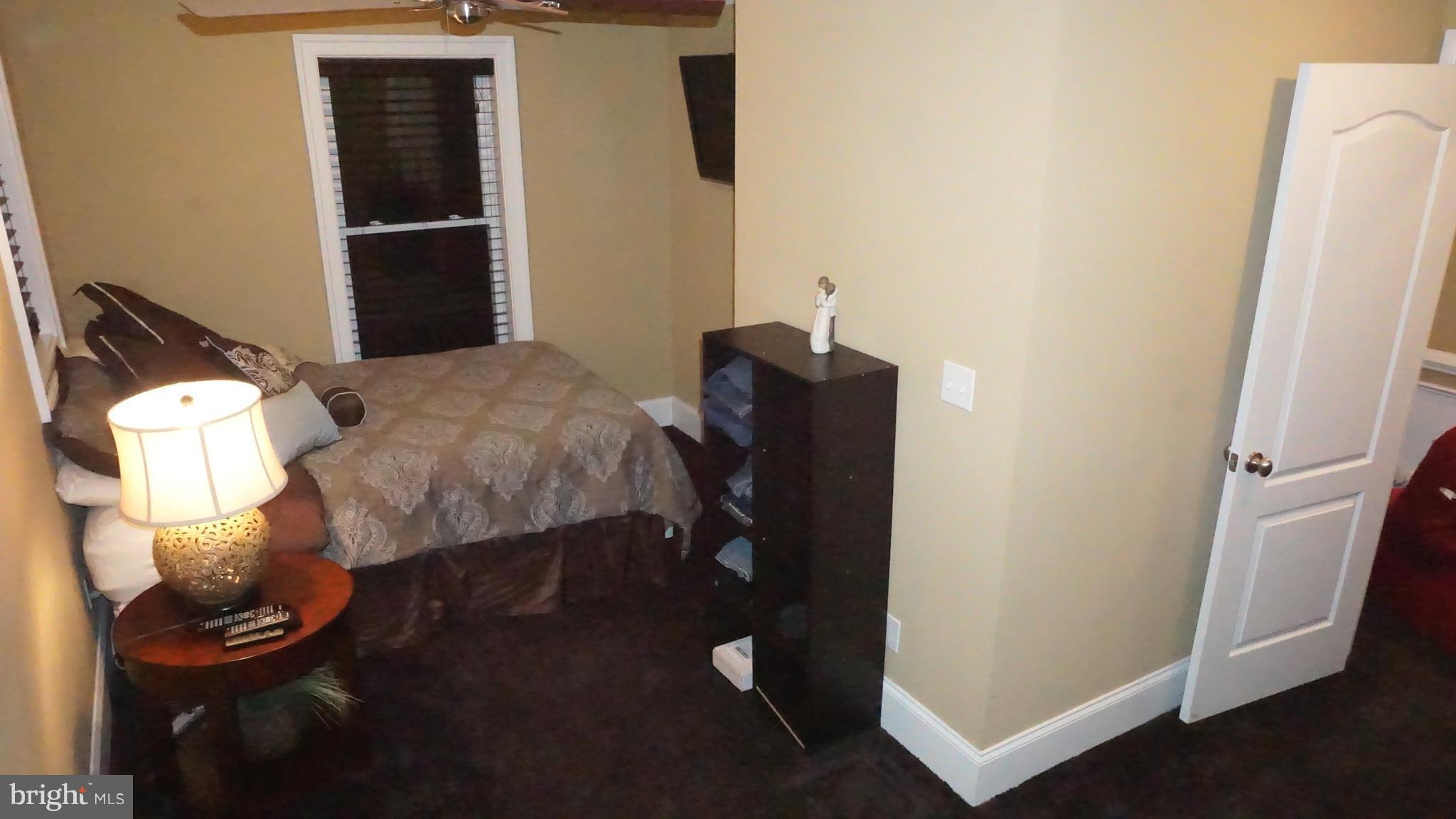 9105 Cuckold Point Road Baltimore, MD 21219 - Photo 85 of 150 a bedroom with a bed and a mirror