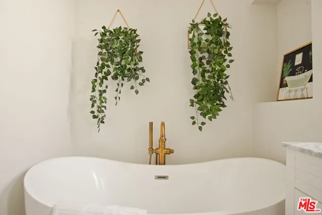 a bedroom with a bed dresser and a window