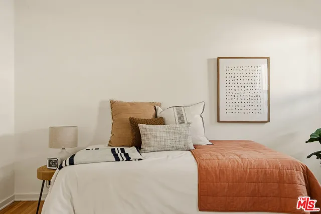 a bedroom with furniture and wooden floor