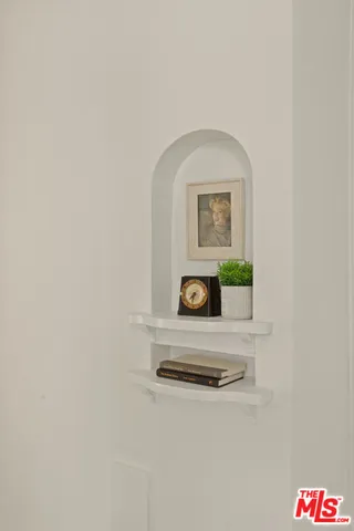 a living room with furniture and a mirror