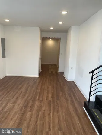 a view of wooden floor and windows in a room