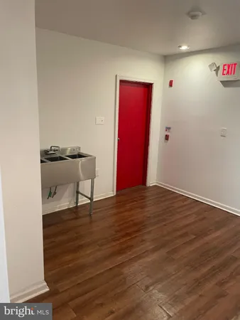 a view of an empty room and wooden floor