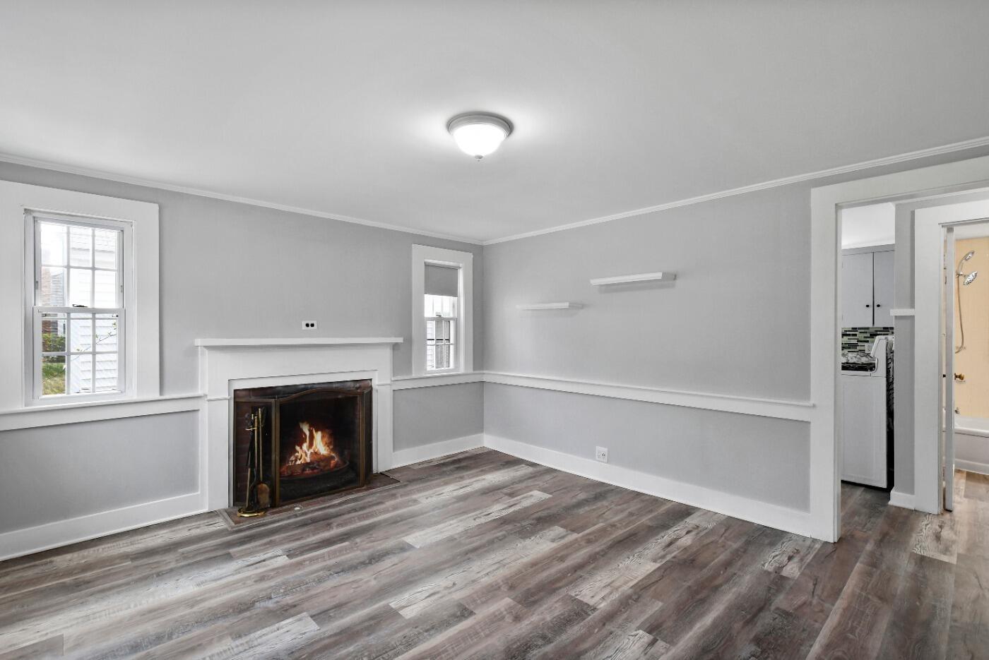 1 Gilbert Road Dennis Port, MA 02639 - Photo 8 of 27 a view of an empty room with a fireplace and a window