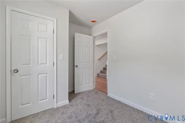 a bathroom with a toilet sink vanity and mirror