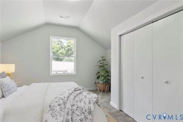 a bathroom with a sink a toilet a mirror and a window