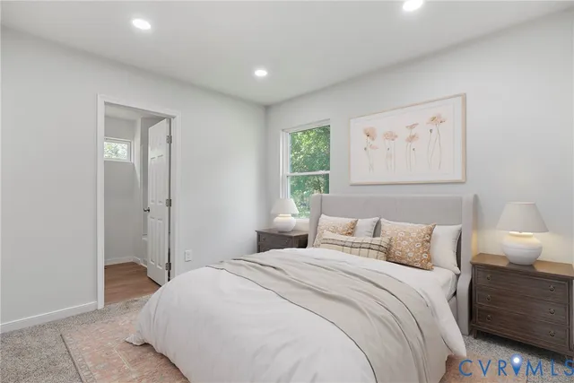 a bedroom with a bed and a night stand