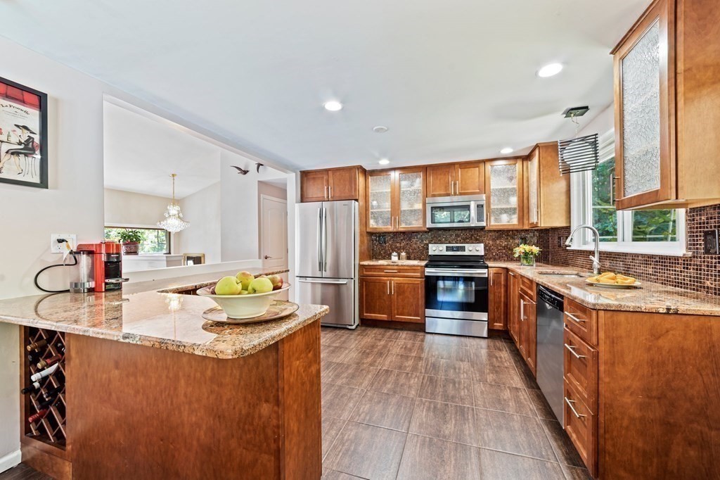 545 Potter Road Framingham, MA 01701 - Photo 2 of 42 a kitchen with stainless steel appliances a stove sink and cabinets