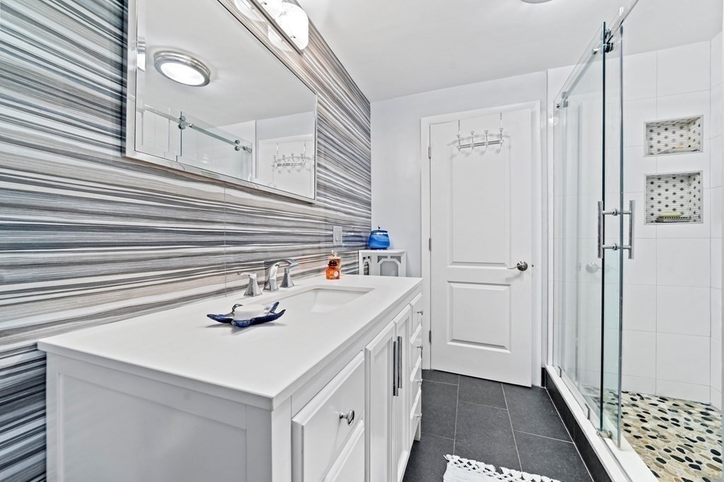 545 Potter Road Framingham, MA 01701 - Photo 7 of 42 a bathroom with a sink a vanity and a shower
