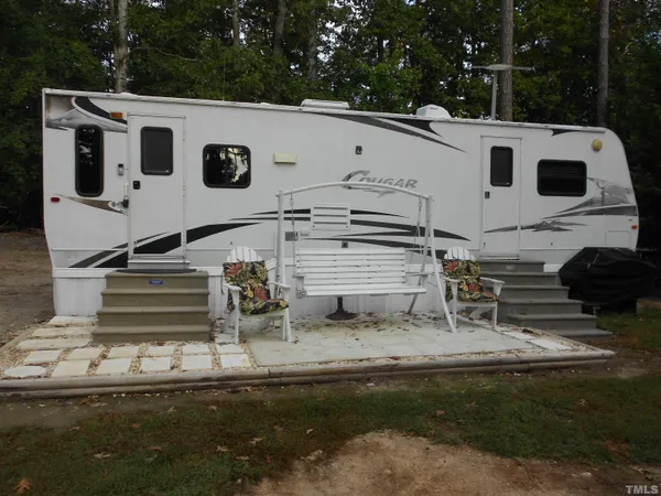 a view of a white house with a yard