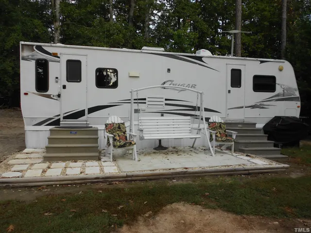 a view of a white house with a yard
