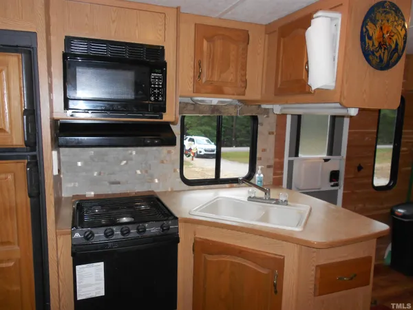 a kitchen with stainless steel appliances granite countertop a stove and a refrigerator