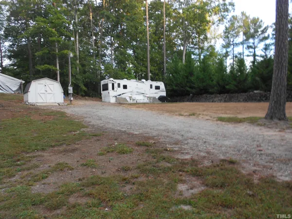 a backyard of a house with table and chairs
