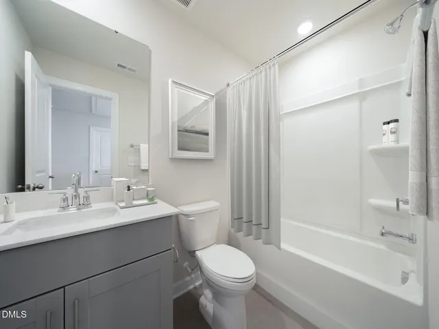 a bathroom with a double vanity sink mirror and shower