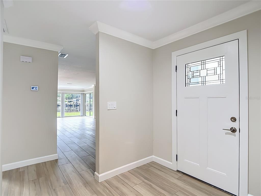 4536 Mitcher Road New Port Richey, FL 34652 - Photo 9 of 46 a view of an empty room with wooden floor and a window