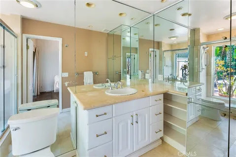a bathroom with a granite countertop sink mirror and a