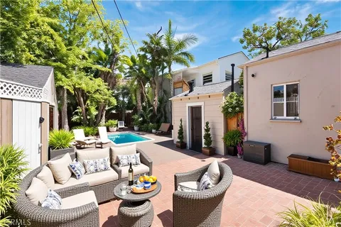 a patio with patio a couch and potted plants