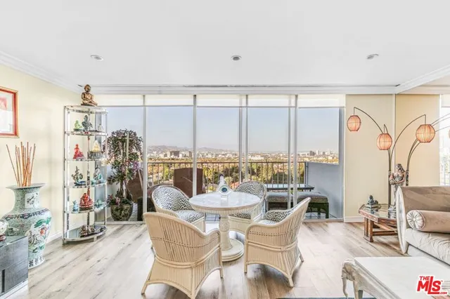 a dining room with furniture and a floor to ceiling window