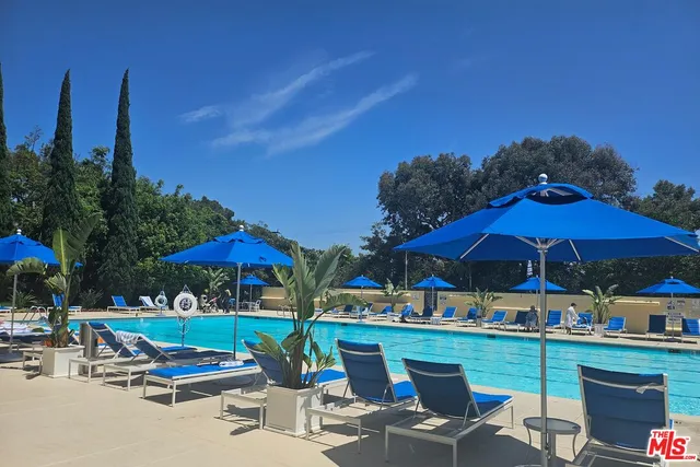 a view of a patio with chairs under an umbrella
