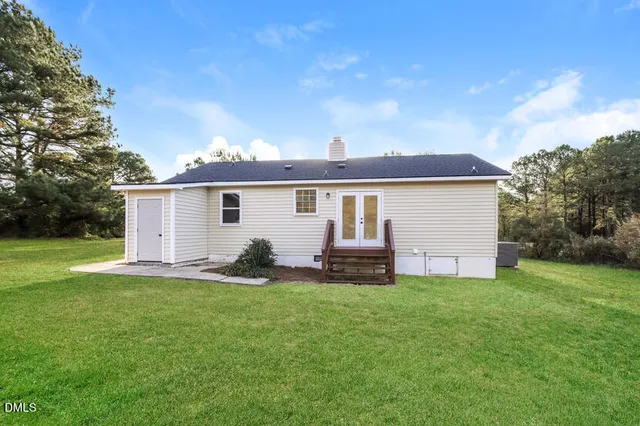 a view of a house with a yard and sitting area