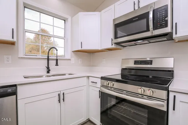 a kitchen with a stove microwave and sink