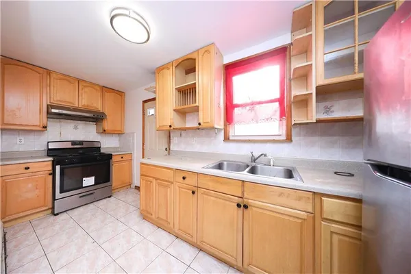a kitchen with a sink cabinets and window