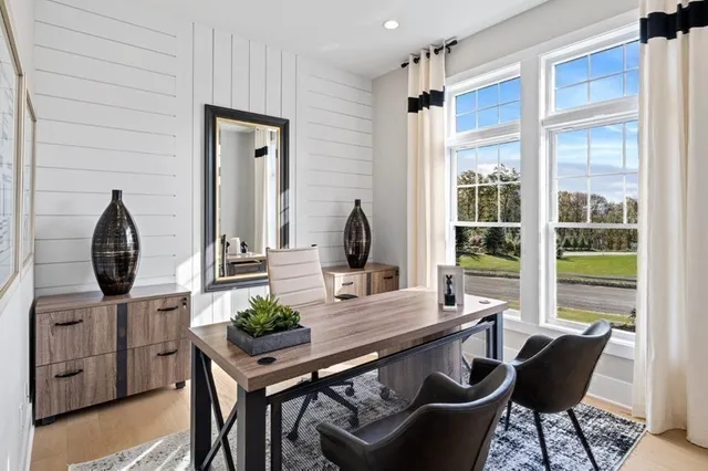 a view of a workspace room with furniture and wooden floor