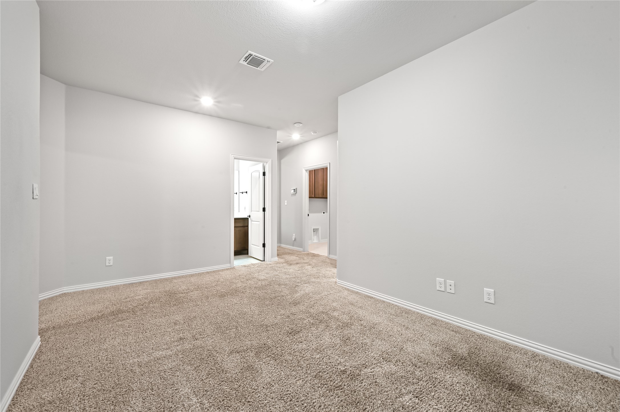 426 Cold Riv Run Kyle, TX 78640 - Photo 21 of 34 A well-lit area provides versatile space, leading to a convenient bathroom and utility zone.