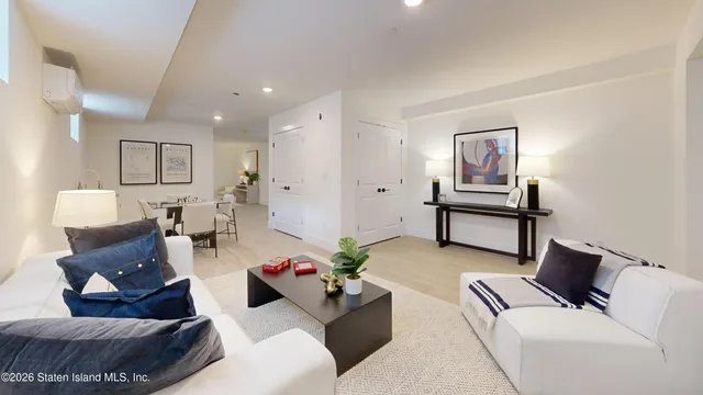 a living room with furniture and a painting on the wall