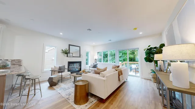 a living room with furniture fireplace and a large window