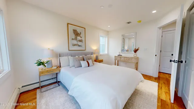 a spacious bedroom with a bed and a cabinets