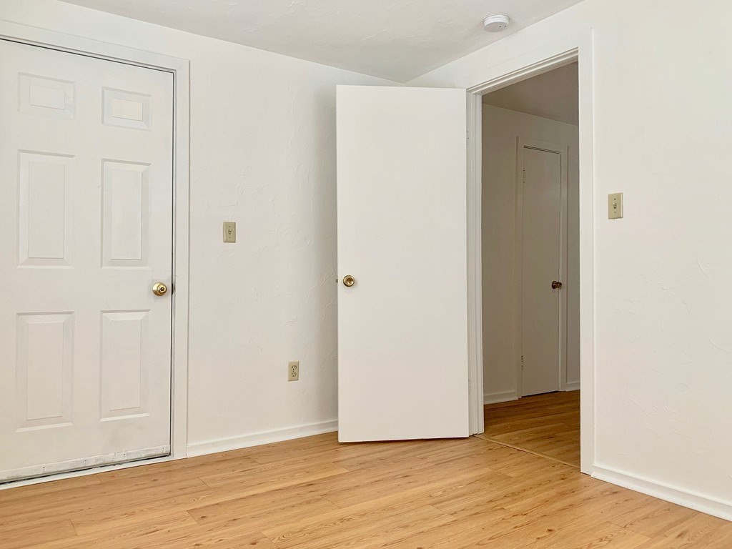 14 Groton Street, Unit 6 Ayer, MA 01432 - Photo 4 of 7 a view of an empty room with wooden floor and closet
