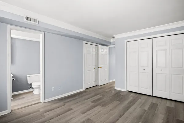 a view of a room with wooden floor and bathroom view