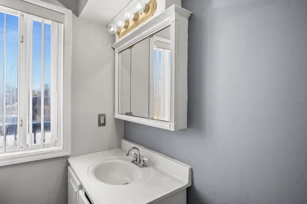 a bathroom with a sink and a mirror