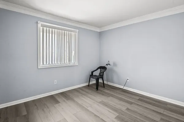 a view of a room with wooden floor and a window
