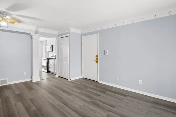 a view of an empty room with wooden floor