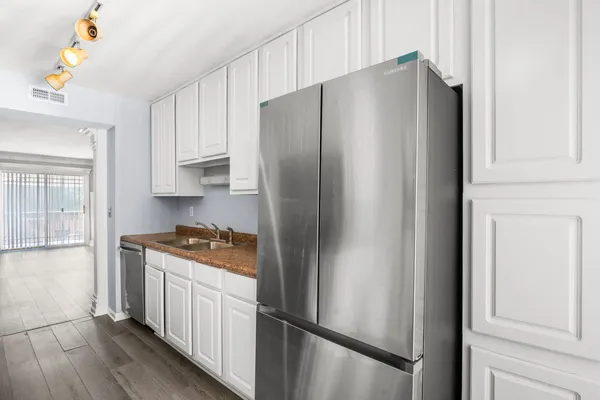 a kitchen with stainless steel appliances a refrigerator and a stove top oven