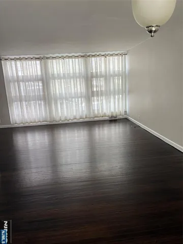 a view of wooden floor and windows in a room