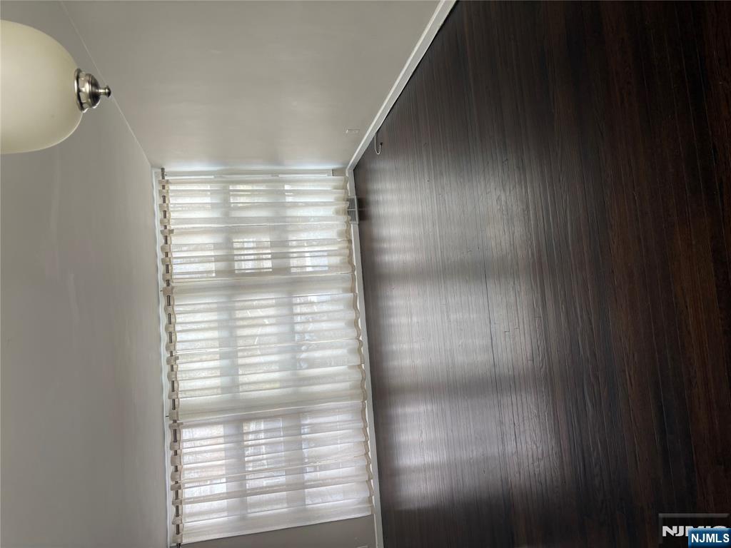 66 Stuart Street, Unit B Waldwick, NJ 07463 - Photo 3 of 11 a view of wooden floor and windows in a room