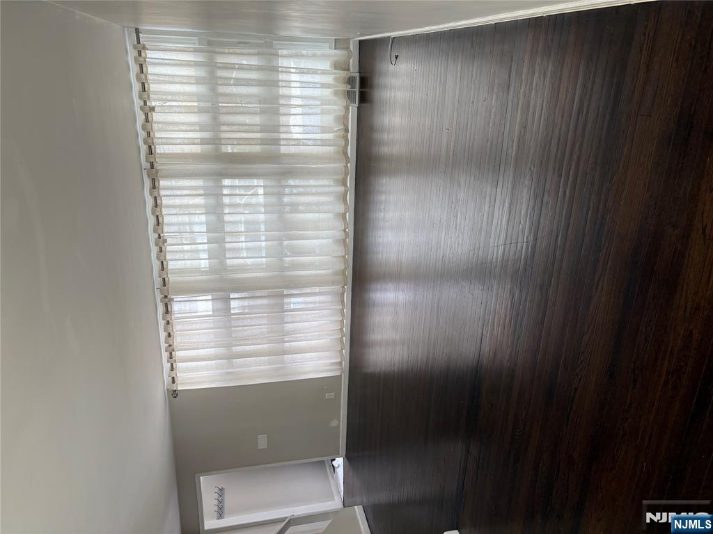 66 Stuart Street, Unit B Waldwick, NJ 07463 - Photo 4 of 11 a view of wooden floor and windows in a room