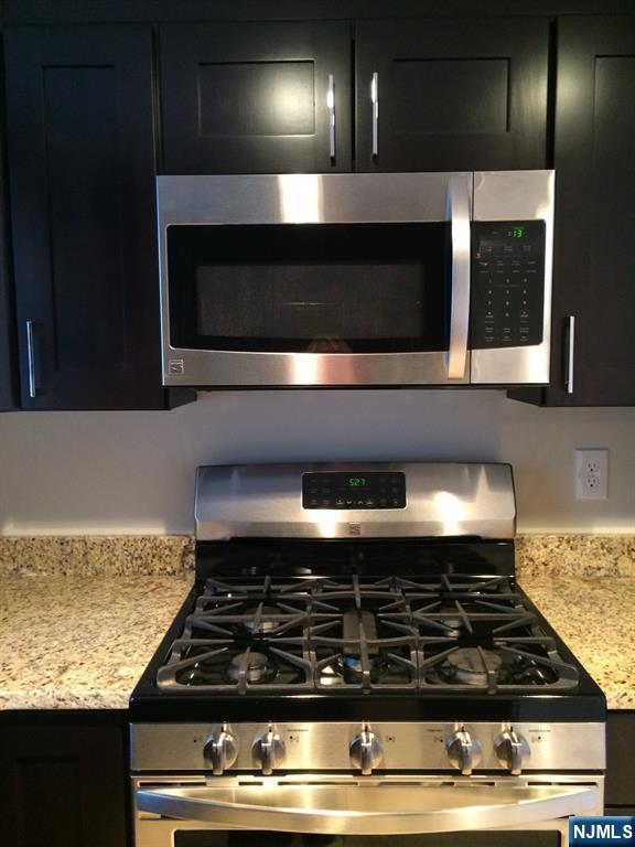 66 Stuart Street, Unit B Waldwick, NJ 07463 - Photo 7 of 11 a stove top oven sitting inside of a kitchen