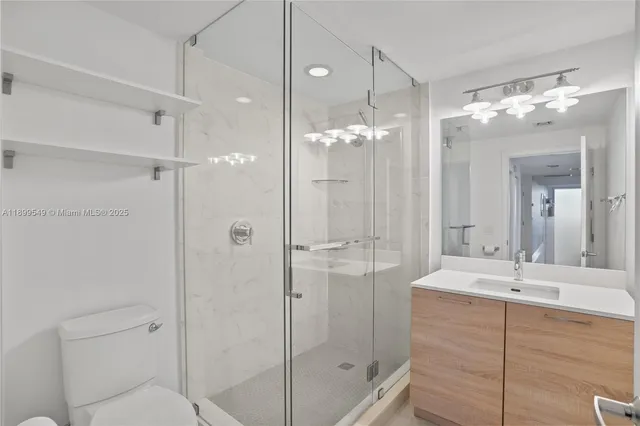 a bedroom with a bed and a view of balcony