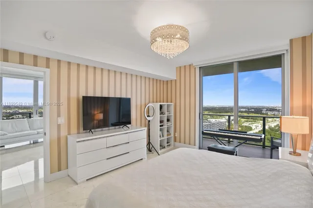 a bathroom with a double vanity sink mirror and chandelier