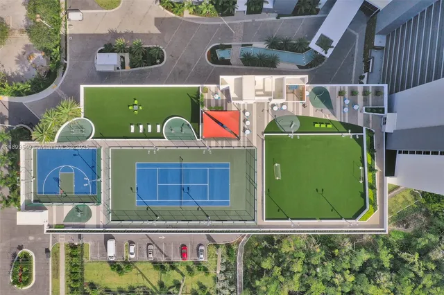 a living room with furniture and large windows