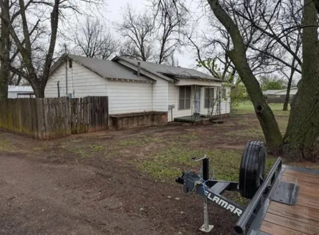 a backyard of a house with table and chairs