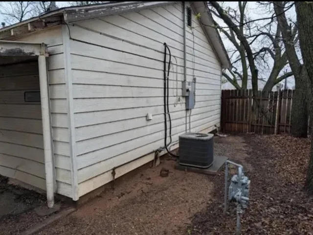 a wooden bench sitting in backside of a house