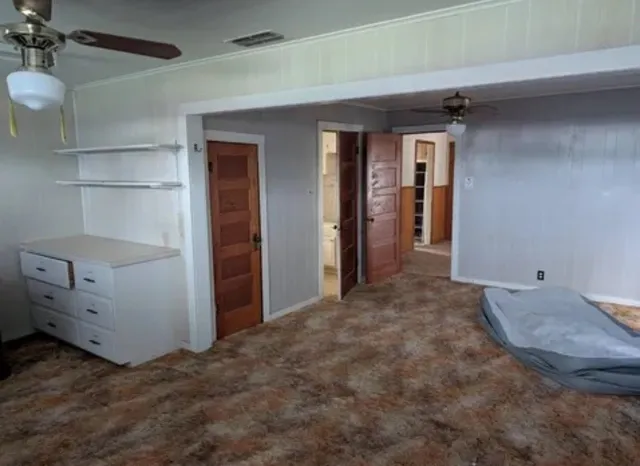 a kitchen with granite countertop white cabinets and black appliances