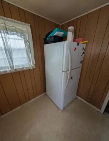 a room with a mirror and a wooden furniture