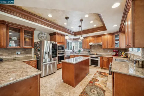 a view of a kitchen with a sink and cabinets